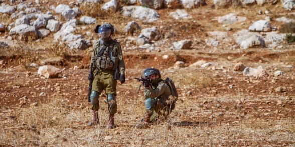 Israeli soldiers aim at Palestinian protesters demonstrating against Israeli settlements in the village of Beit Dajan near the West Bank city of Nablus on November 4, 2022. Credit: SOPA Images Limited/Alamy Live News