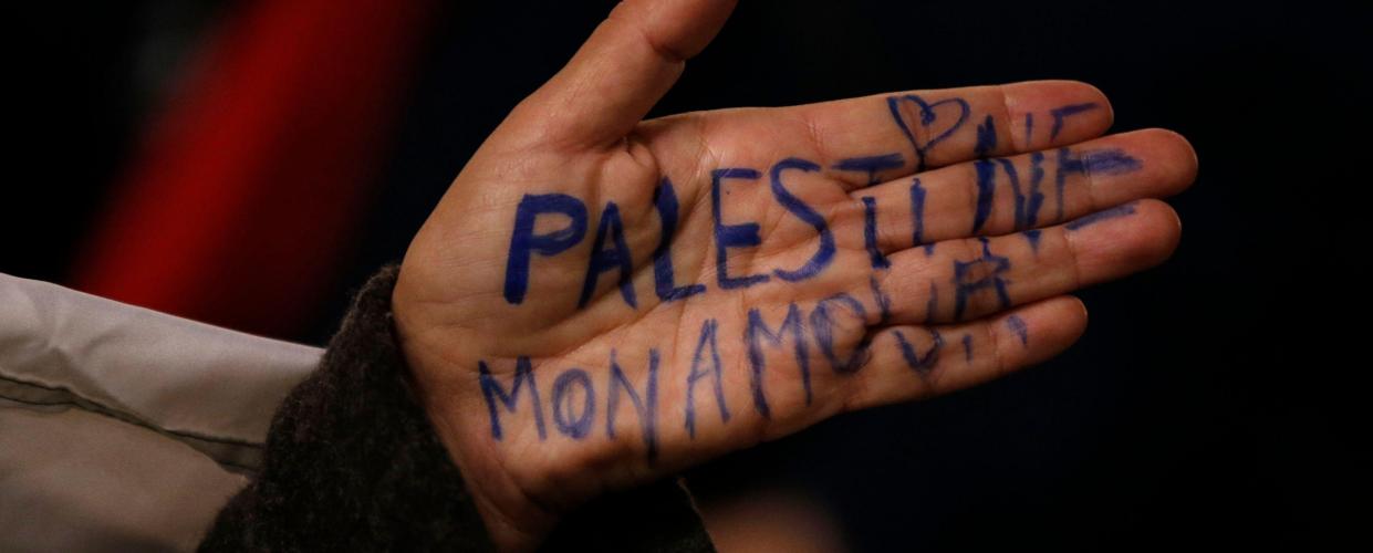 A pro-Palestinian supporter displays the message, "Palestine my Love" as she takes part in a demonstration in front of the Paris Opera house to protest against Israel's Prime Minister's visit in France, October 31, 2012. Israel's Prime Minister is on a two-day visit in France. REUTERS/Christian Hartmann 