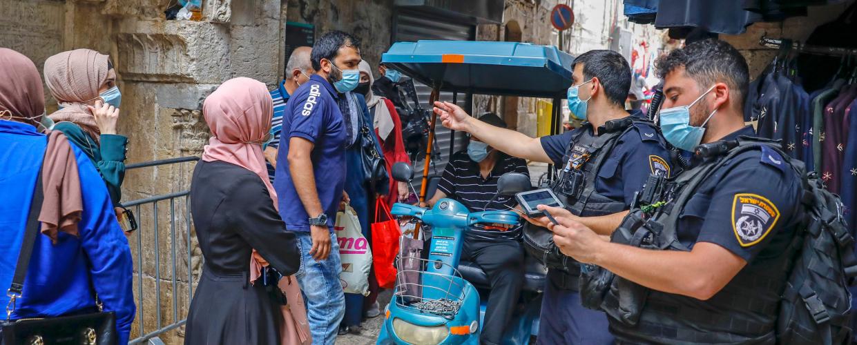 Israeli police officers enforce coronavirus regulations in Jerusalem's Old City, on July 9, 2020. (Photo by Ahmad Gharabli/AFP via Getty Images)