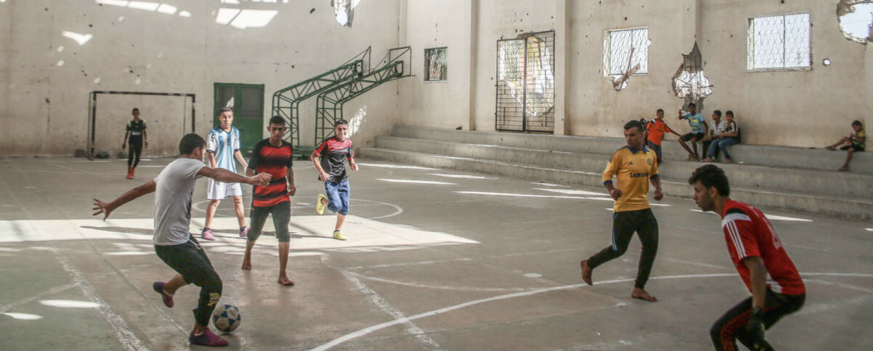 Boys playing football in a bombed out gym in Gaza. From a series of photos commissioned by British NGO, Medical Aid for Palestine (2014)